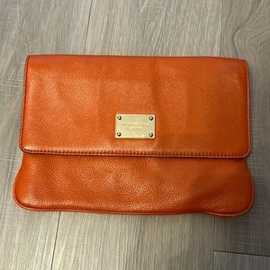 Michael Kors orange leather clutch bag